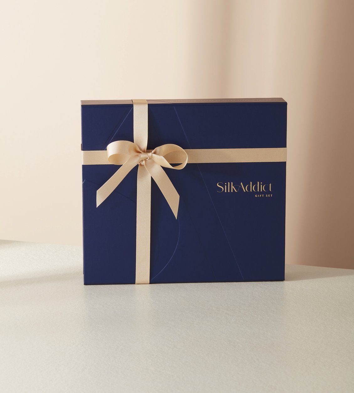 luxury silk gift set in white featuring a sleep mask, pillowcase and two hair scrunchies